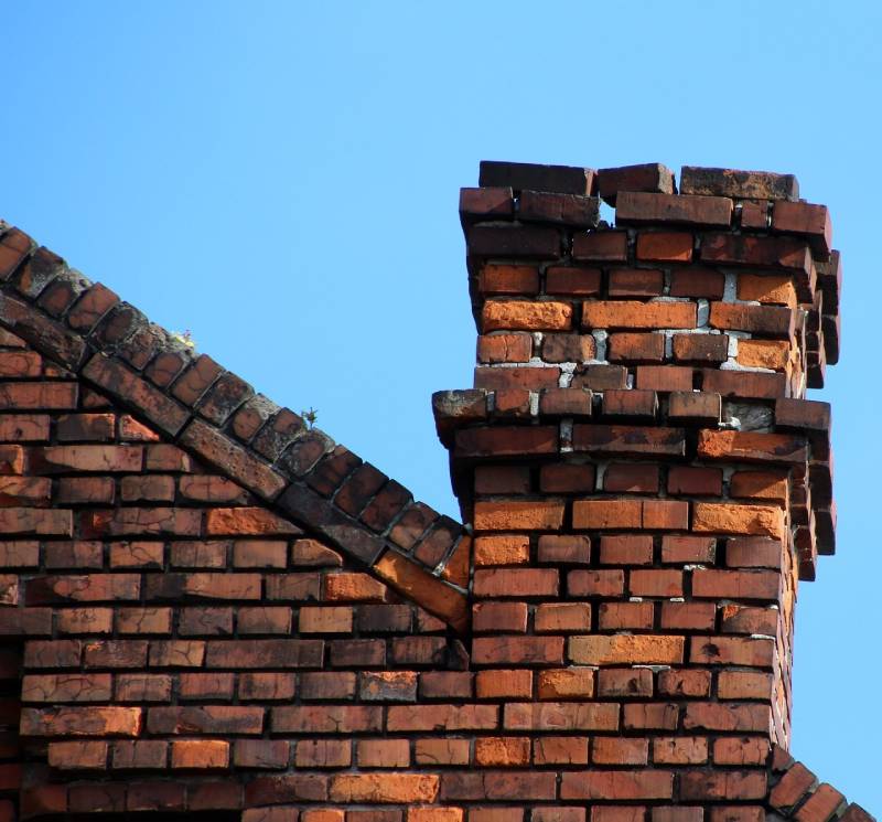 Damaged chimney on an Crofton home showing cracks and missing mortar